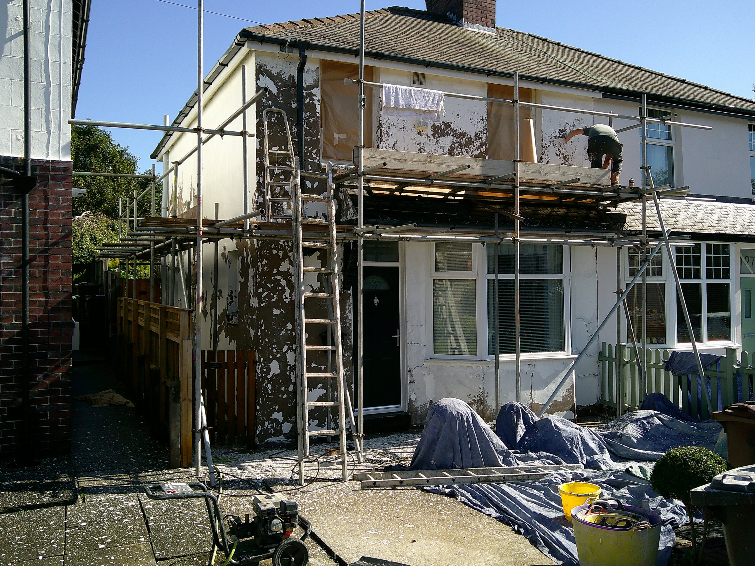 Pebbledash removed from an exterior wall before coating